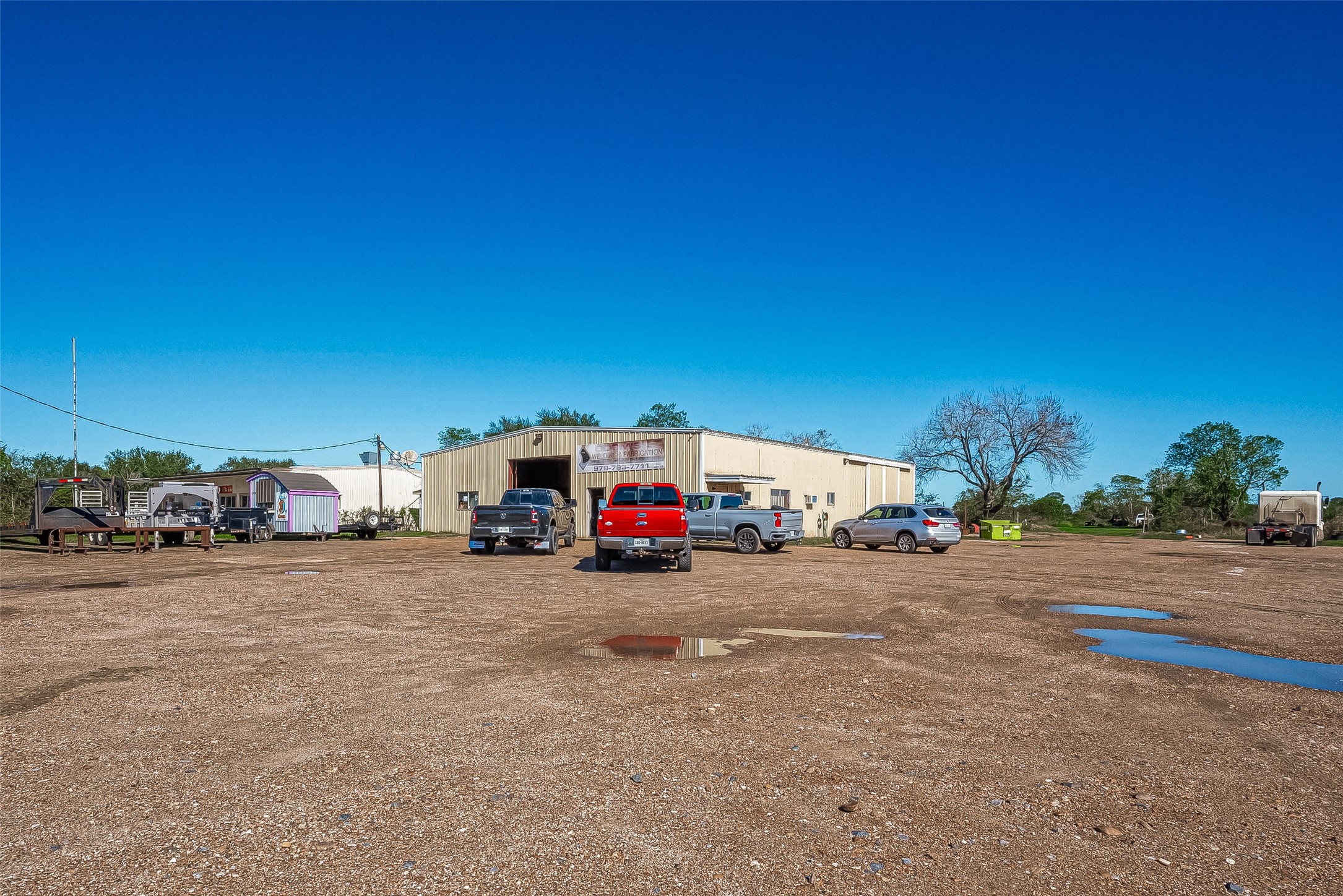 8231 Main Street Needville, TX 77461 - Photo 5 of 43 a view of a road with a building in the background