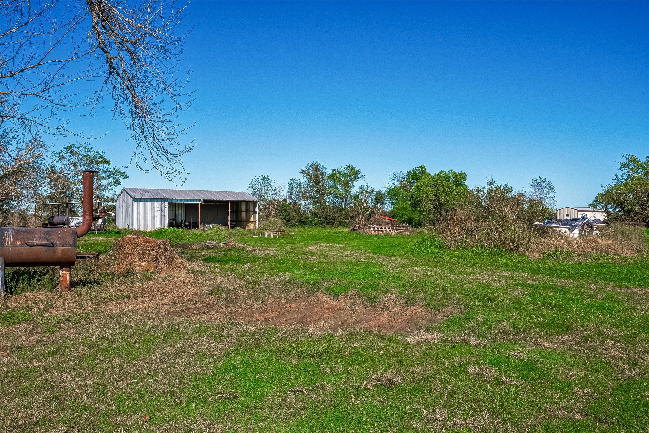 8231 Main Street Needville, TX 77461 - Photo 10 of 43 a backyard of a house with table and chairs