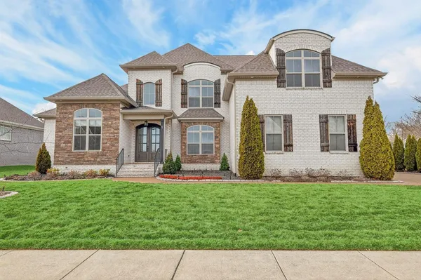 a front view of a house with a yard