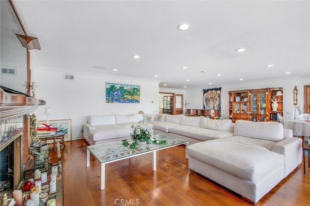 a living room with furniture a rug and a large window