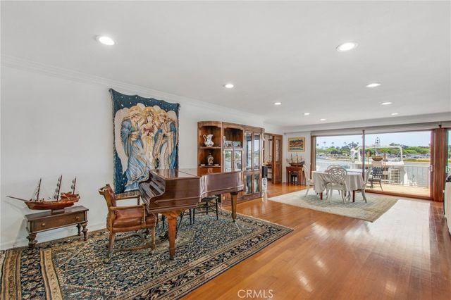 a view of a dining room with furniture large windows and wooden floor