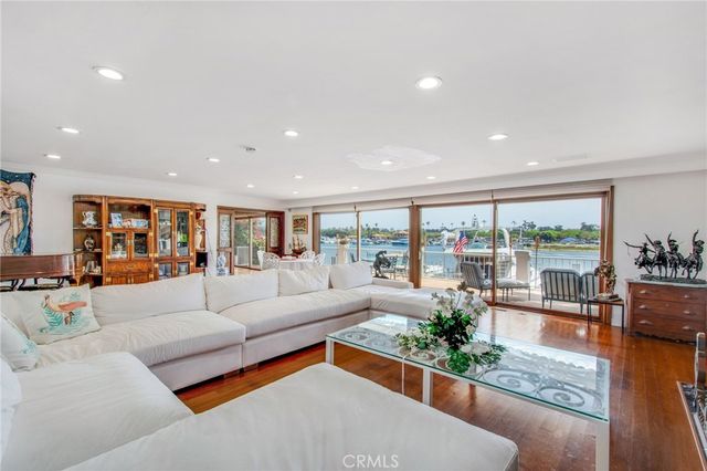 a dining room with stainless steel appliances granite countertop a dining table and chairs with wooden floor