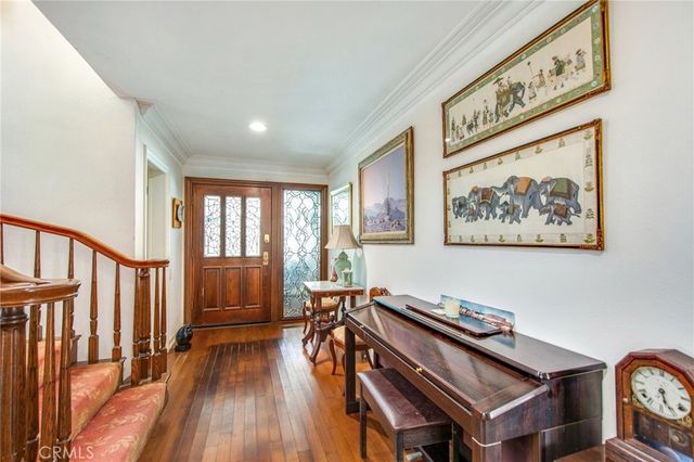a view of entryway with wooden floor and stairs