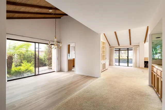 a view of an empty room with a fireplace and a large window