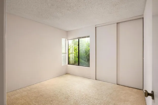 a bathroom with a granite countertop sink a mirror and a shower
