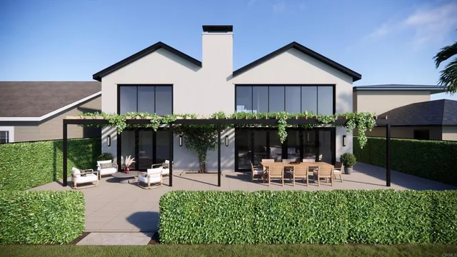 a view of a house with backyard and sitting area