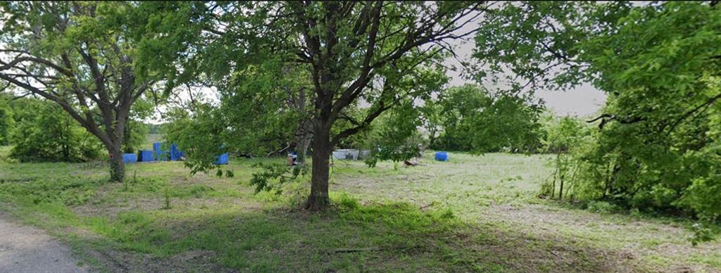 104 Short Street Grandview, TX 76050 - Photo 1 of 3 a view of a yard with a tree