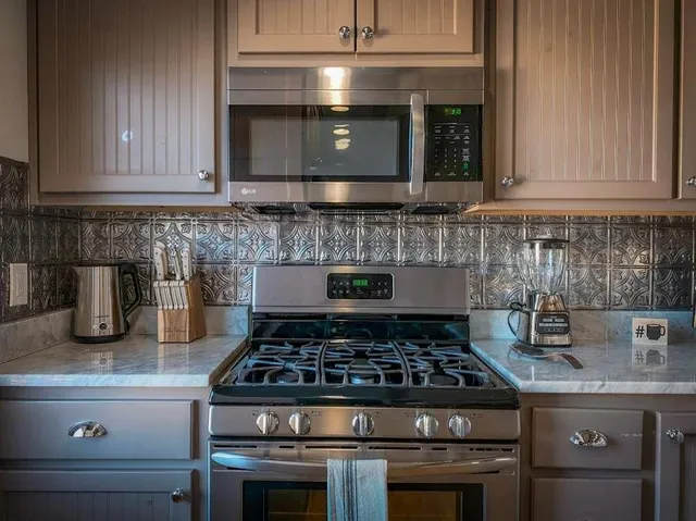 a stove top oven sitting inside of a kitchen