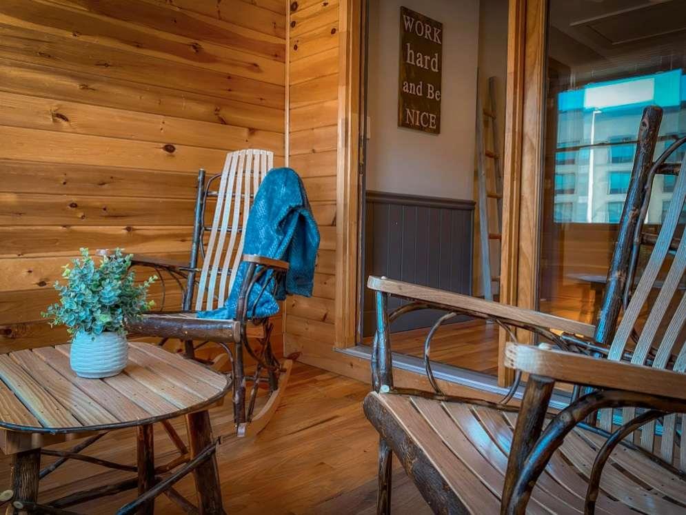 544 East Main Street, Unit 2 Blue Ridge, GA 30513 - Photo 9 of 19 a view of a balcony with chairs and a potted plant