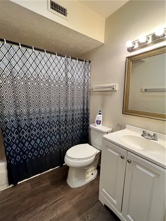 a bathroom with a sink toilet and mirror