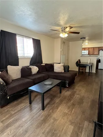 a living room with furniture and a lamp