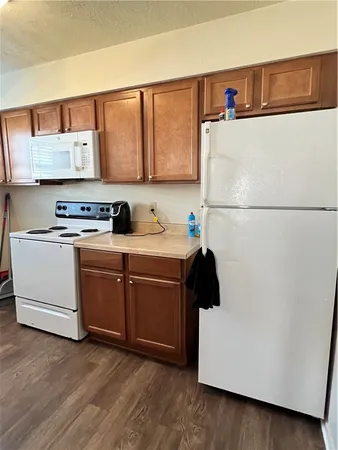 a kitchen with a refrigerator and a stove