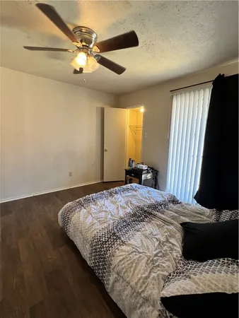 a bedroom with a bed and a flat tv screen
