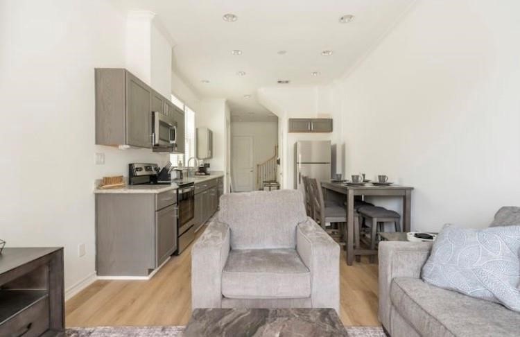 3231 Real Street, Unit B Houston, TX 77087 - Photo 6 of 25 a living room with stainless steel appliances kitchen island granite countertop furniture and a fireplace
