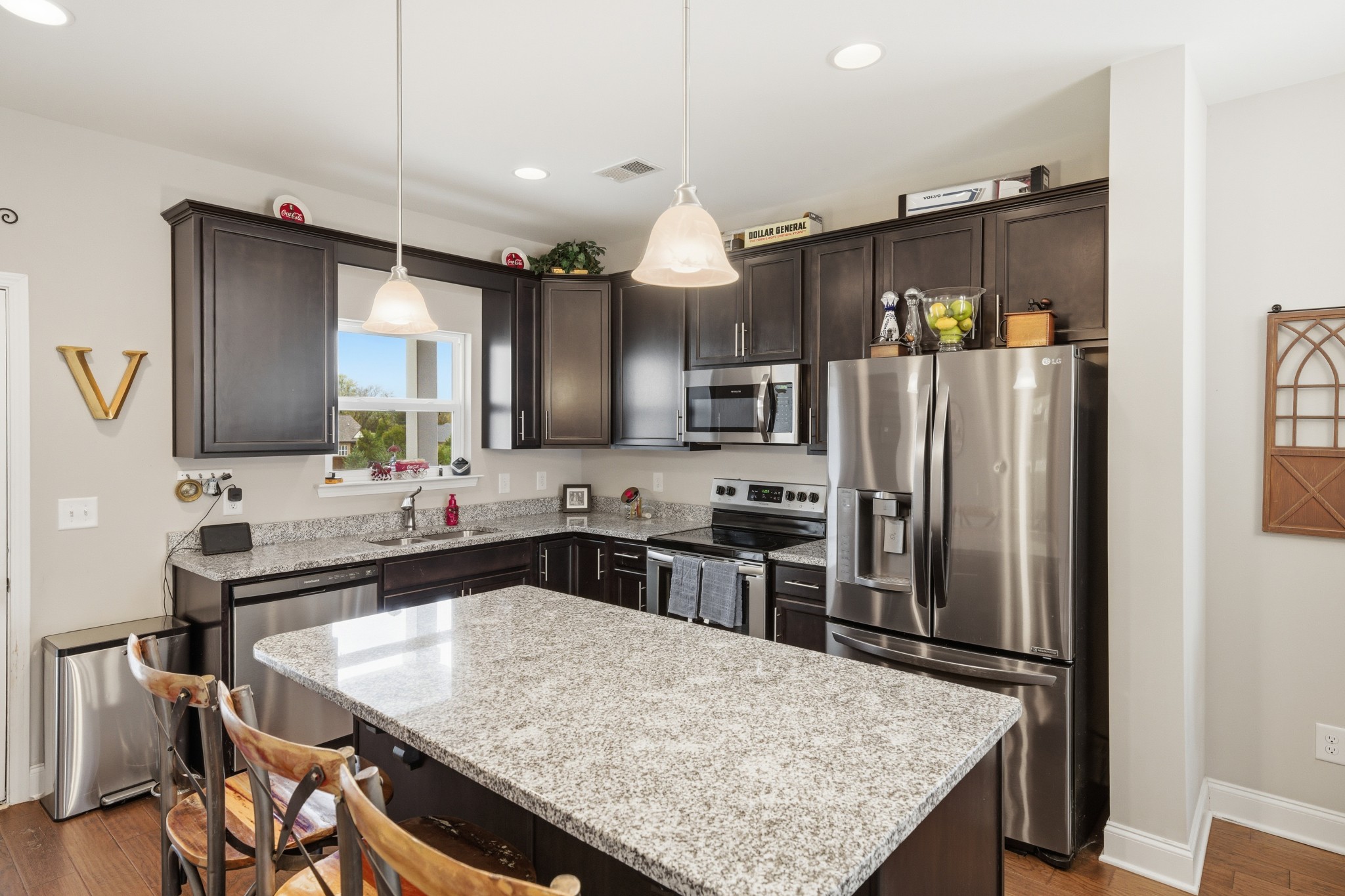 1319 Coates Lane Gallatin, TN 37066 - Photo 14 of 32 a kitchen with granite countertop a refrigerator a stove a sink a dining table and chairs
