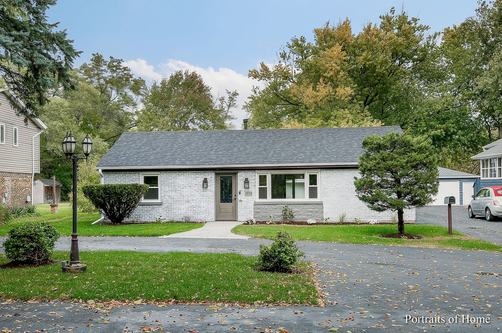 a front view of house with yard and green space