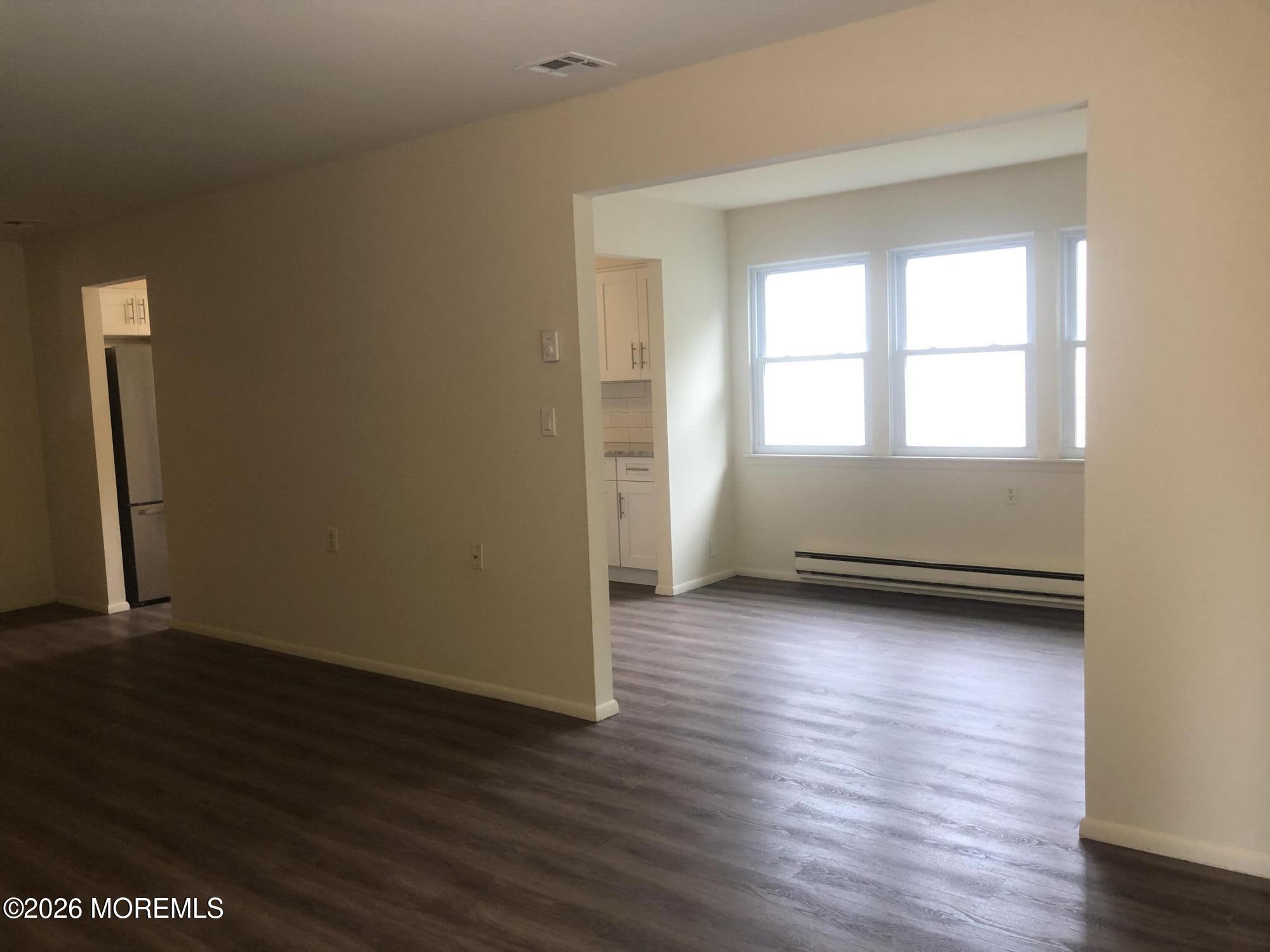 6 Dickinson Road Brick, NJ 08724 - Photo 10 of 17 an empty room with wooden floor and windows
