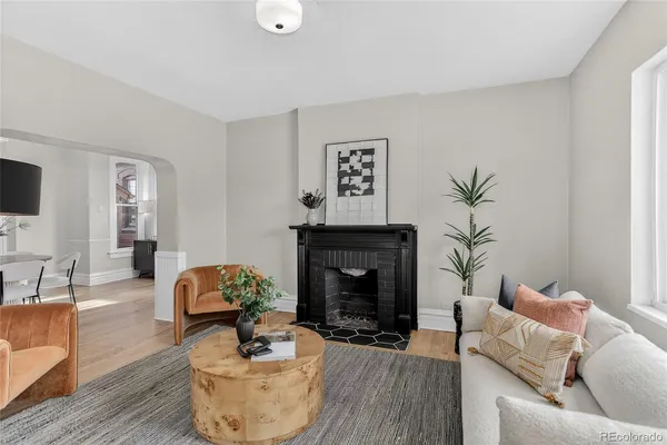 a living room with furniture and a fireplace