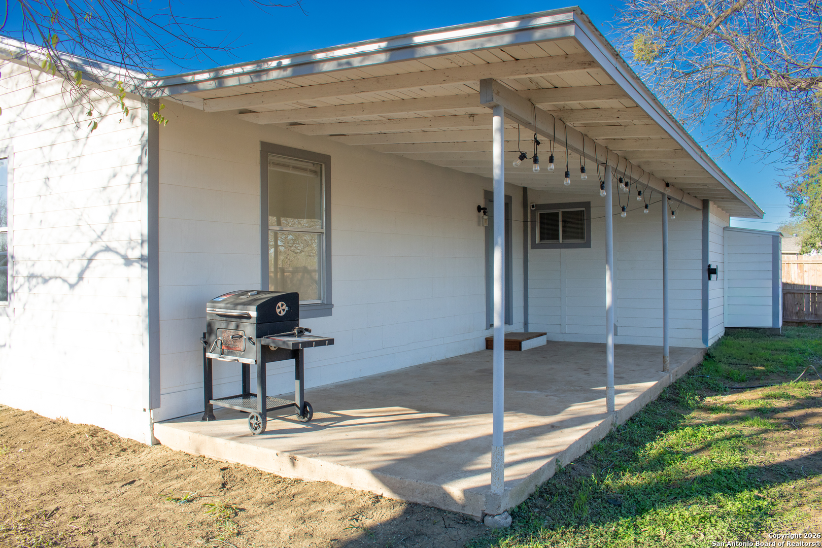 409 Coughran Street Pleasanton, TX 78064 - Photo 15 of 16 a view of a patio with a table and chairs