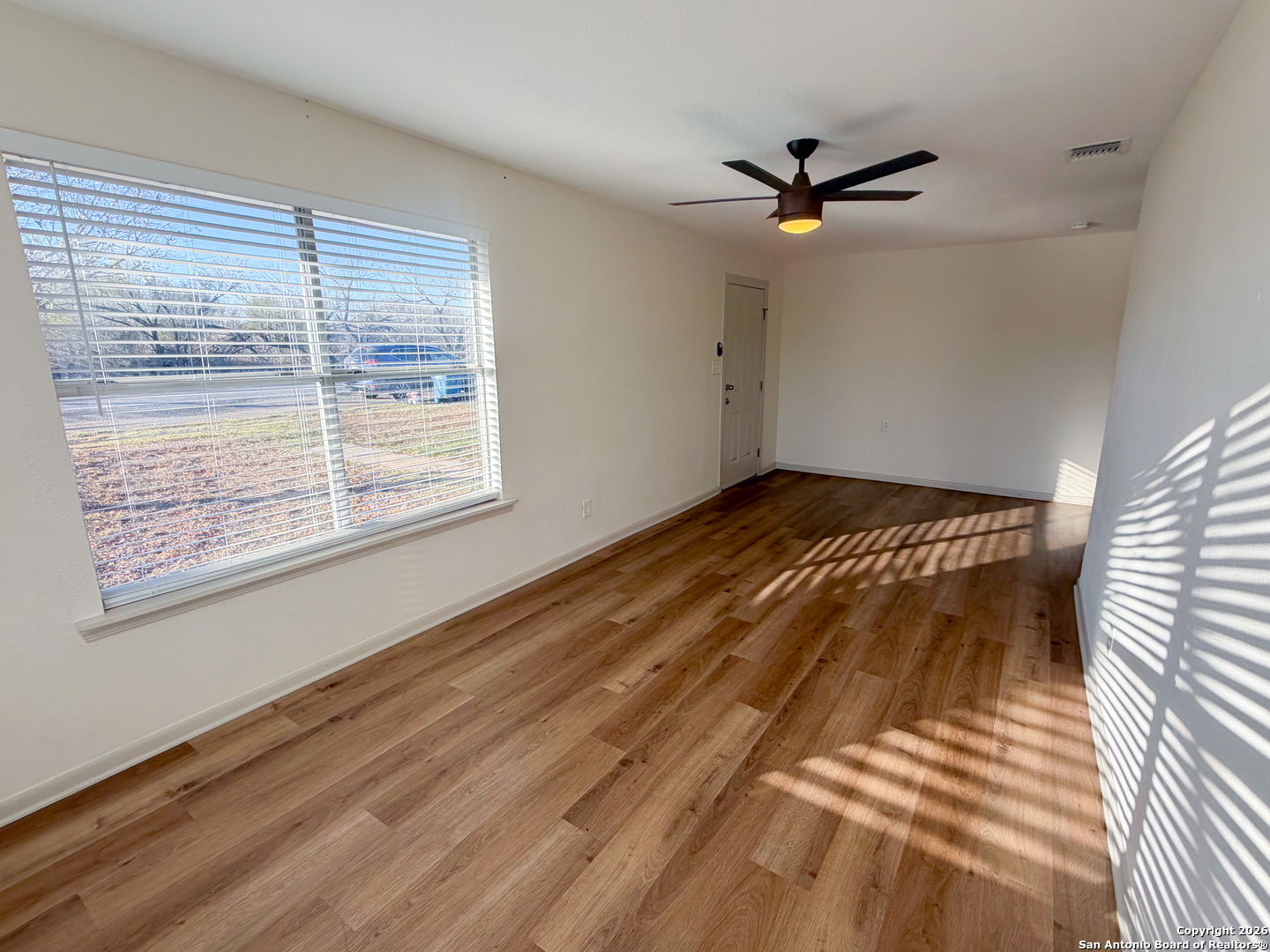 409 Coughran Street Pleasanton, TX 78064 - Photo 4 of 16 a view of a livingroom with a ceiling fan and window