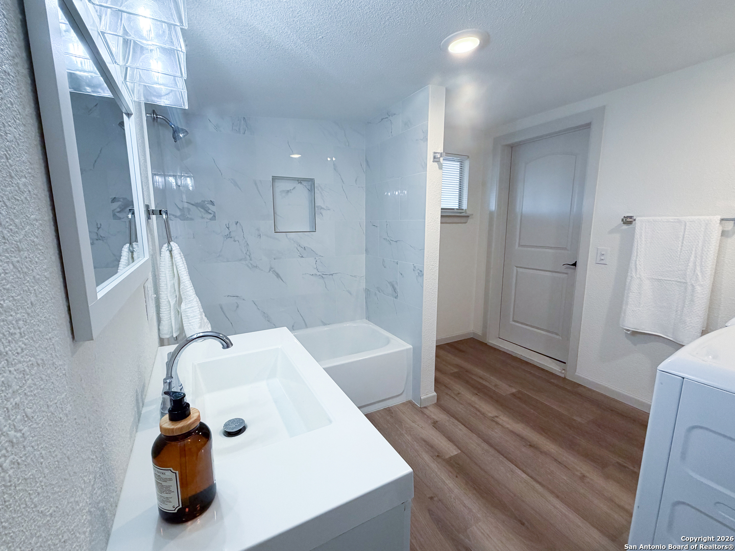 409 Coughran Street Pleasanton, TX 78064 - Photo 8 of 16 a bathroom with a tub sink and shower