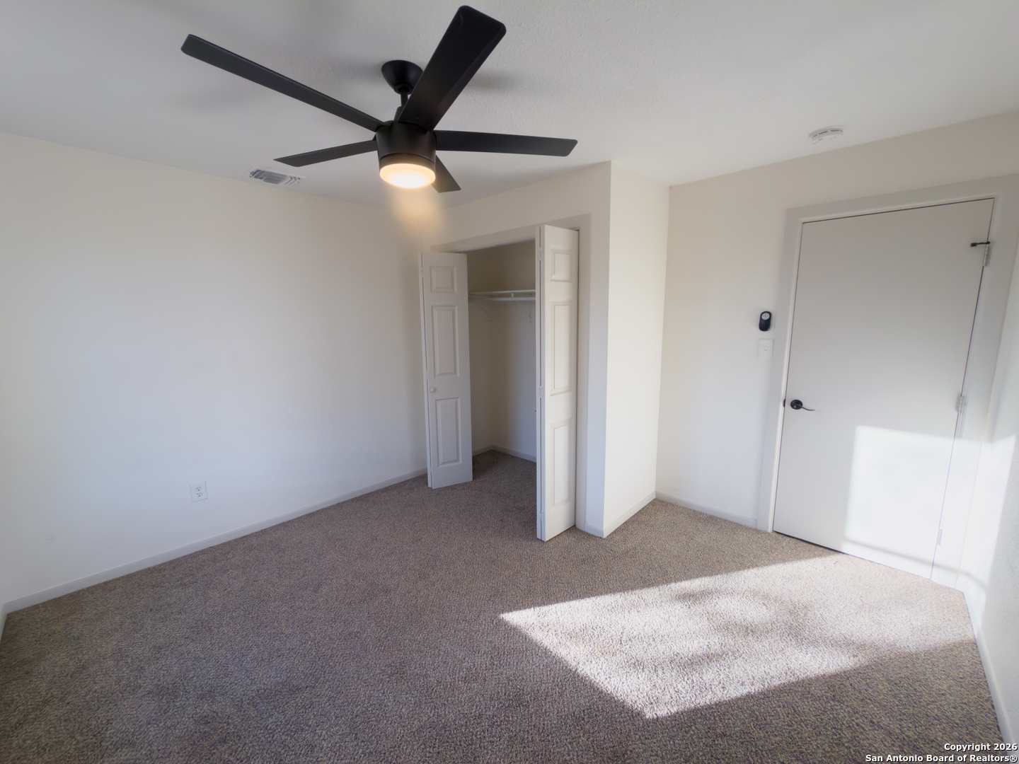409 Coughran Street Pleasanton, TX 78064 - Photo 9 of 16 an empty room with closet and a ceiling fan