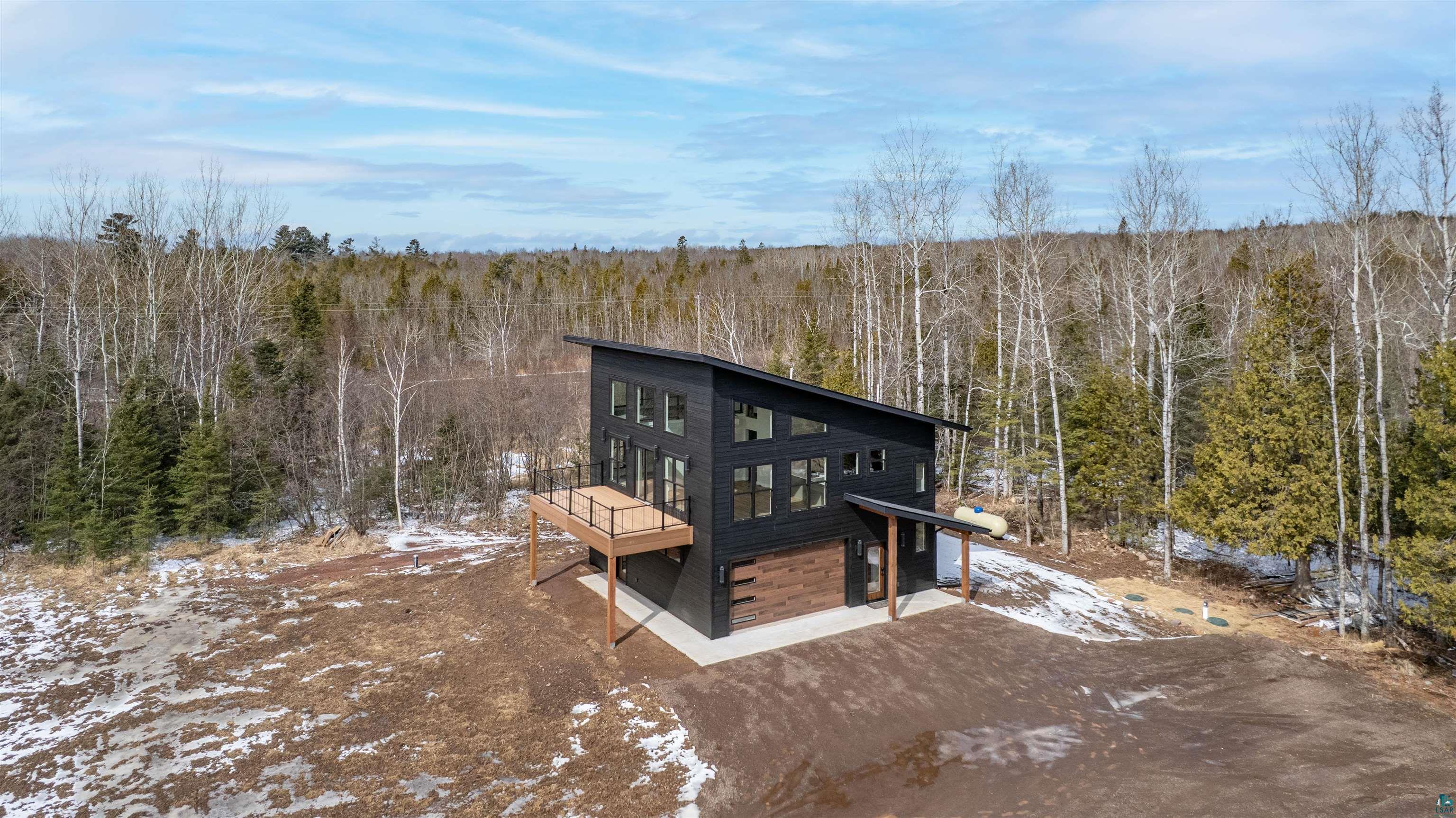 3089 Lavis Road Duluth, MN 55804 - Photo 14 of 30 Rear view of house featuring a wooden deck, dirt driveway, and a view of trees