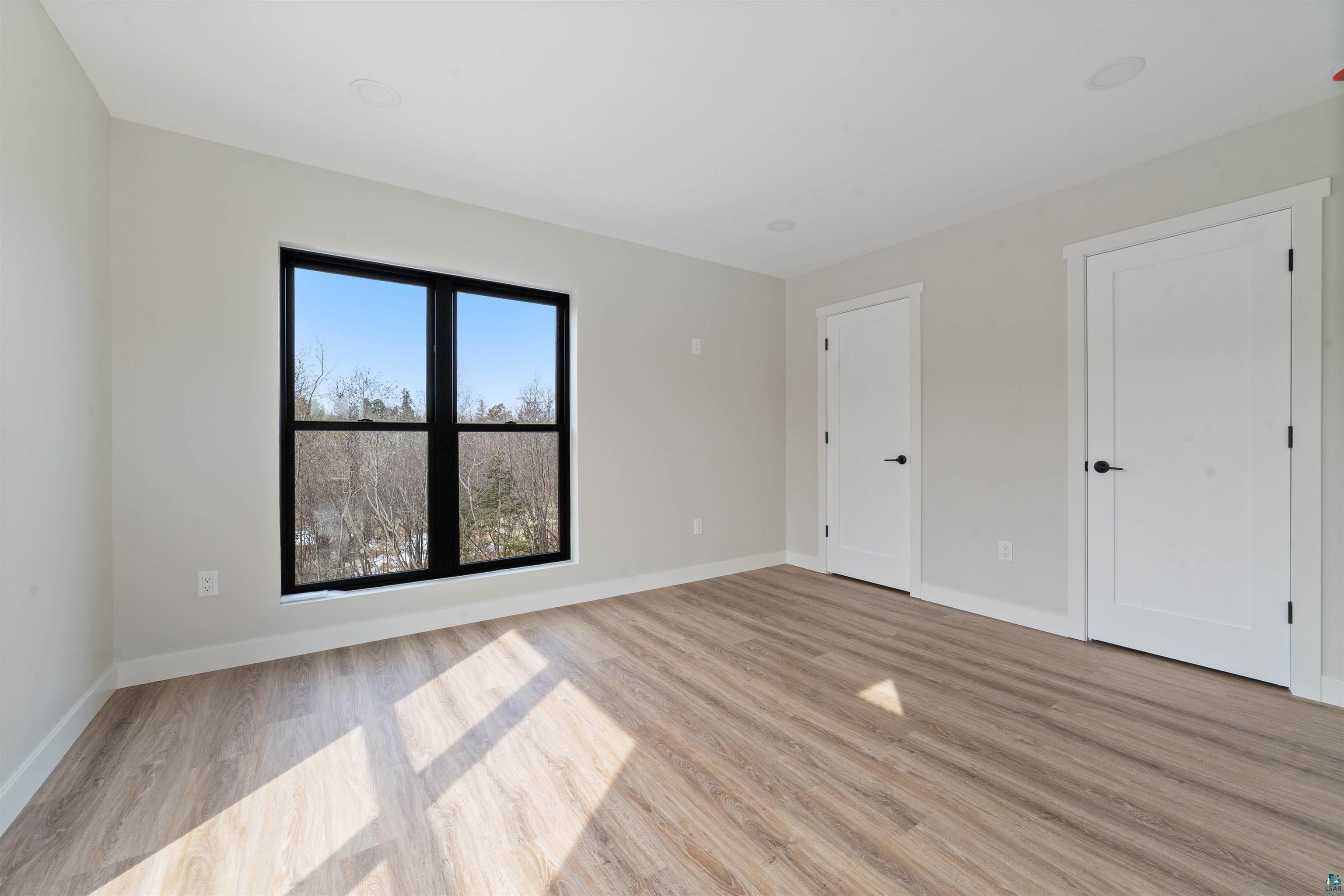 3089 Lavis Road Duluth, MN 55804 - Photo 23 of 30 Unfurnished bedroom with baseboards and light wood-style flooring
