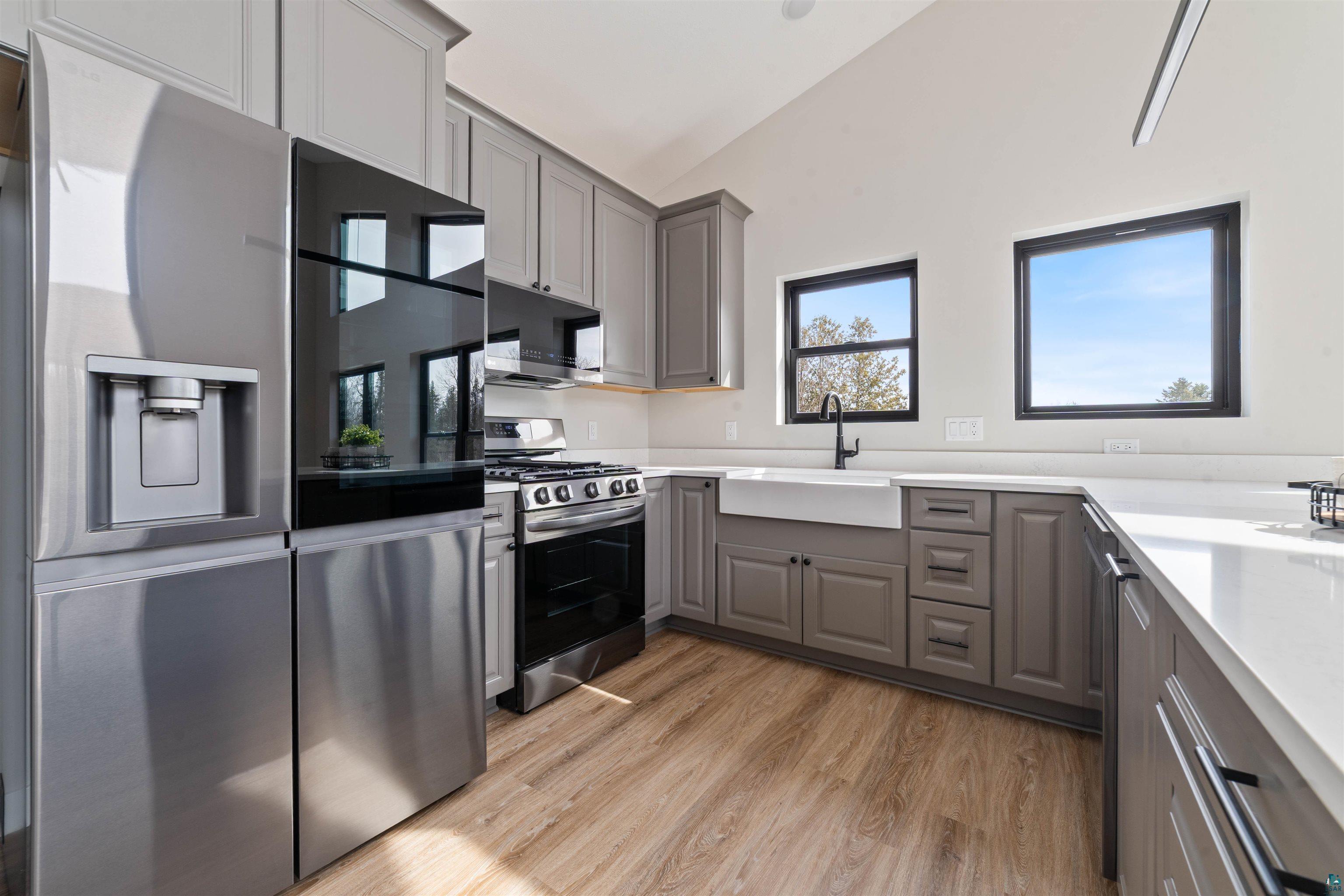 3089 Lavis Road Duluth, MN 55804 - Photo 3 of 30 Kitchen with a sink, lofted ceiling, stainless steel appliances, and gray cabinets