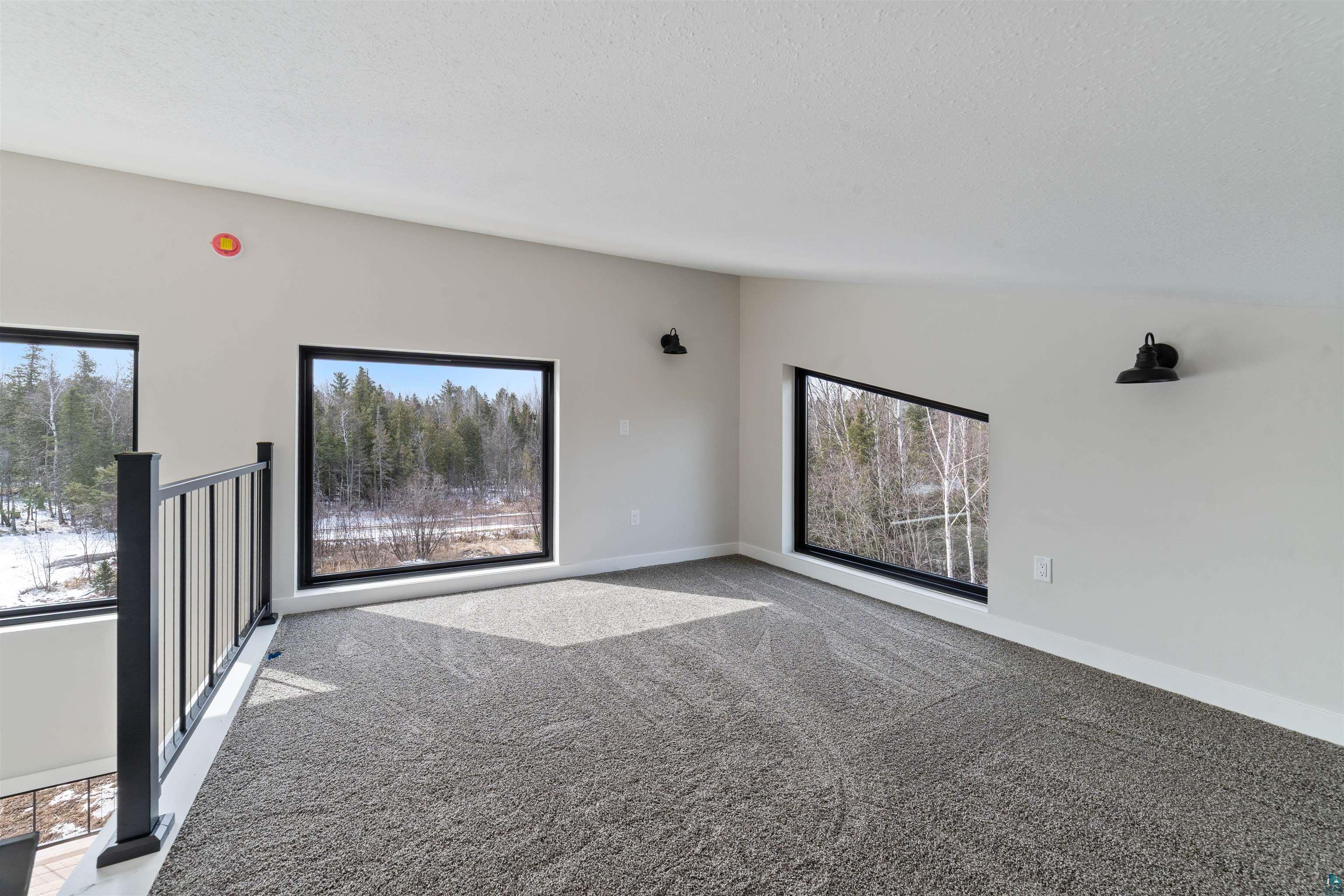 3089 Lavis Road Duluth, MN 55804 - Photo 10 of 30 Carpeted spare room with baseboards and a textured ceiling