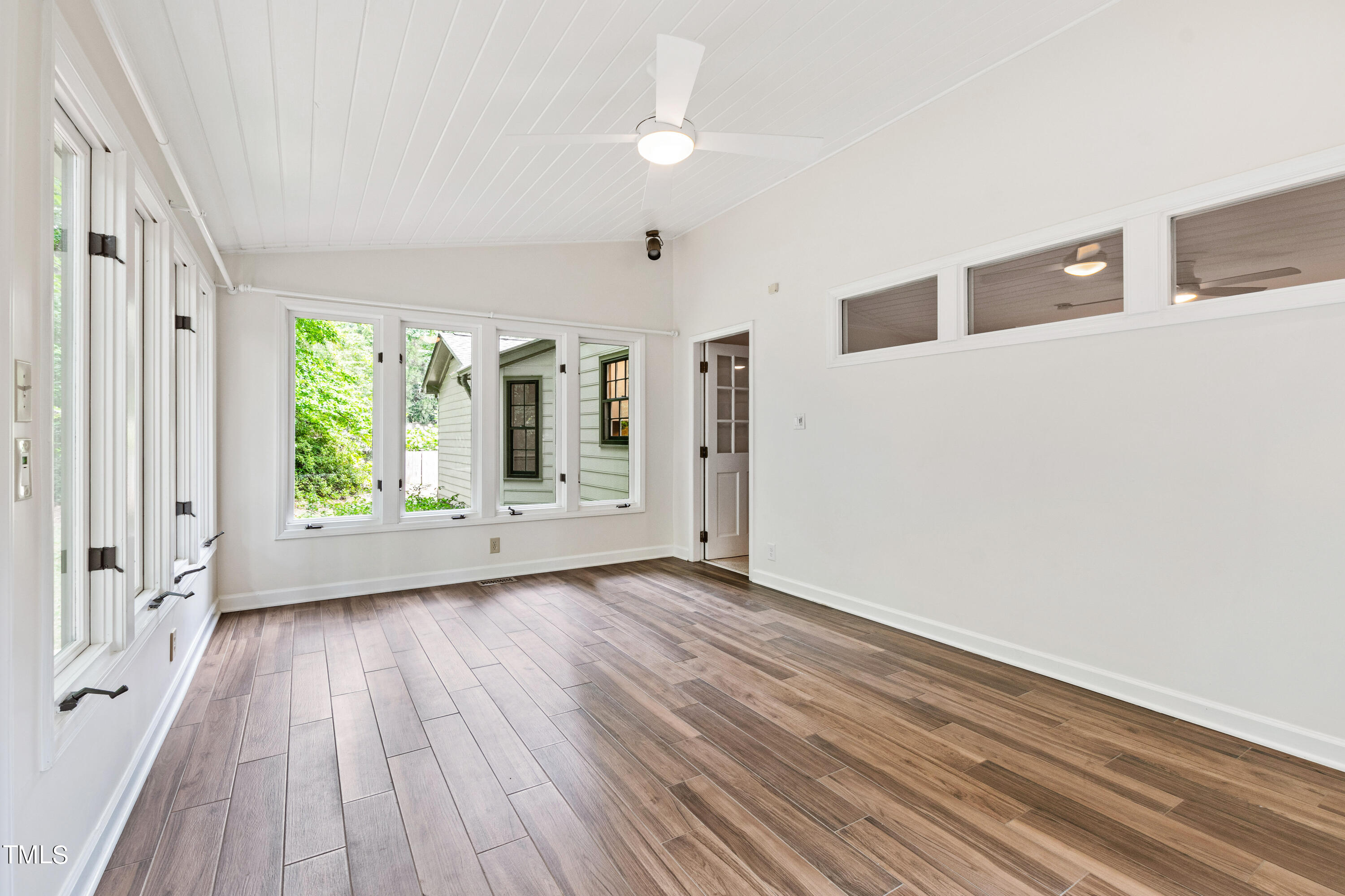 7801 Blackwing Court Raleigh, NC 27615 - Photo 14 of 40 a view of an empty room with wooden floor and a window