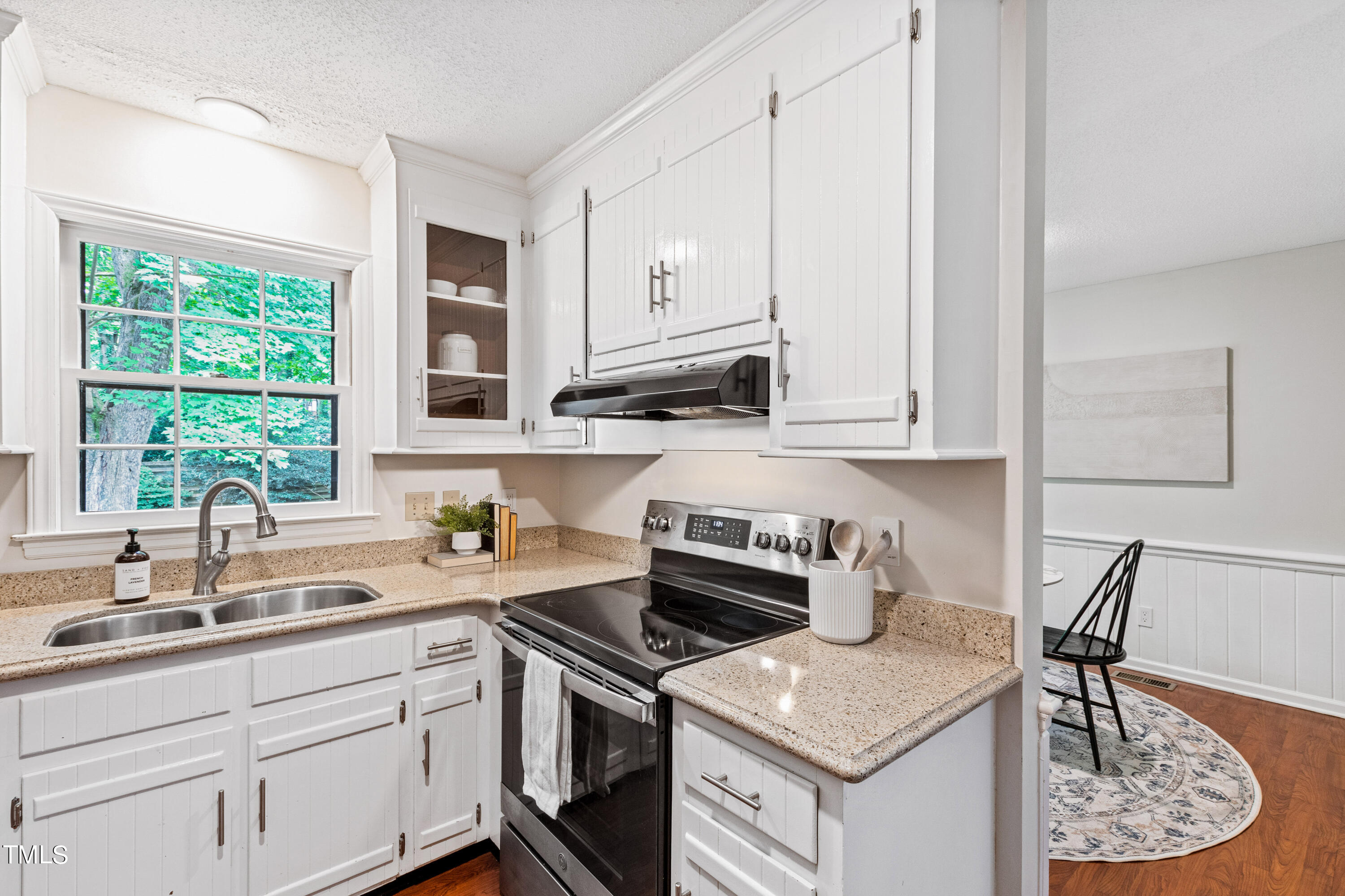 7801 Blackwing Court Raleigh, NC 27615 - Photo 17 of 40 a kitchen with cabinets appliances a sink and a window