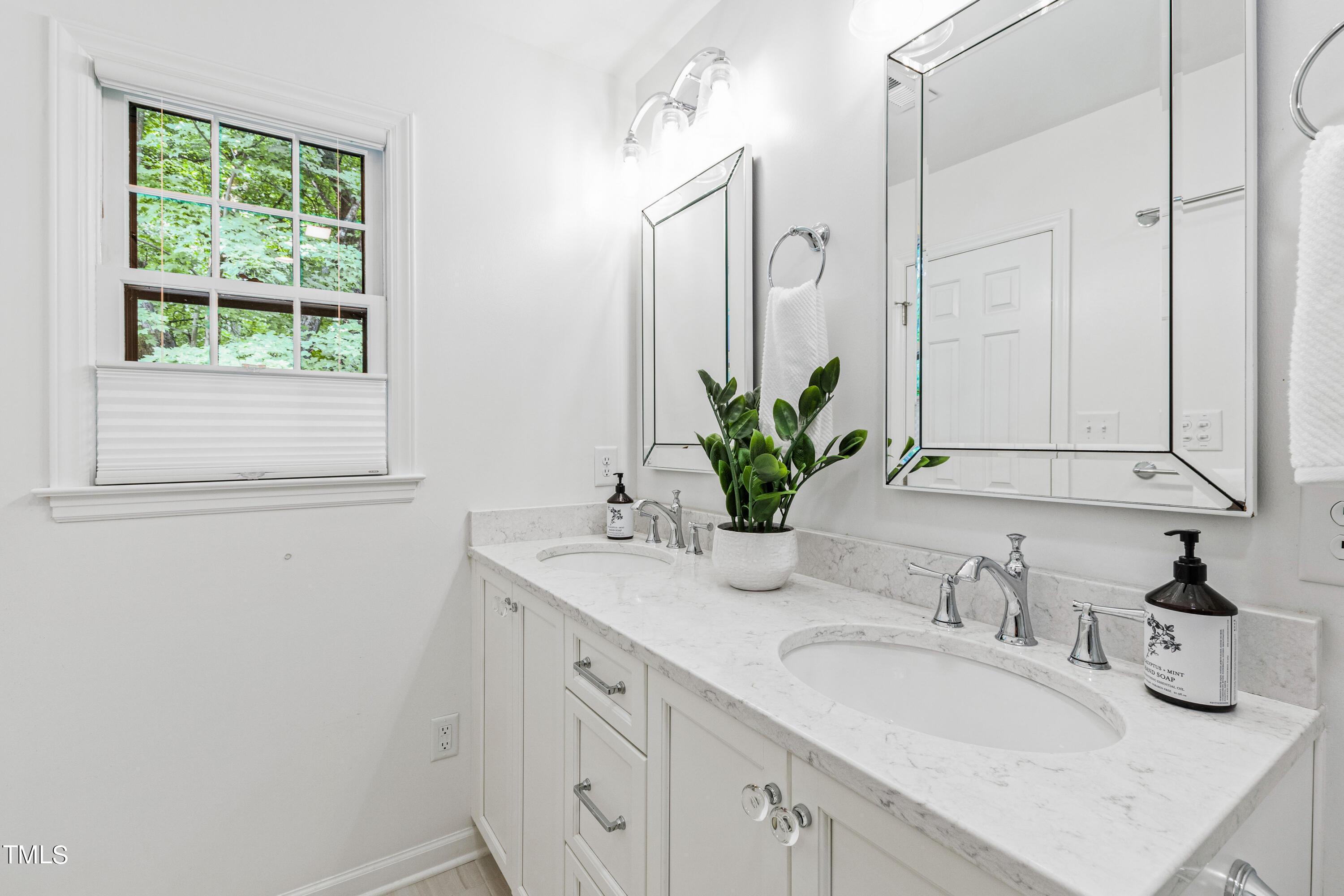 7801 Blackwing Court Raleigh, NC 27615 - Photo 27 of 40 a bathroom with a granite countertop sink a mirror and a shower