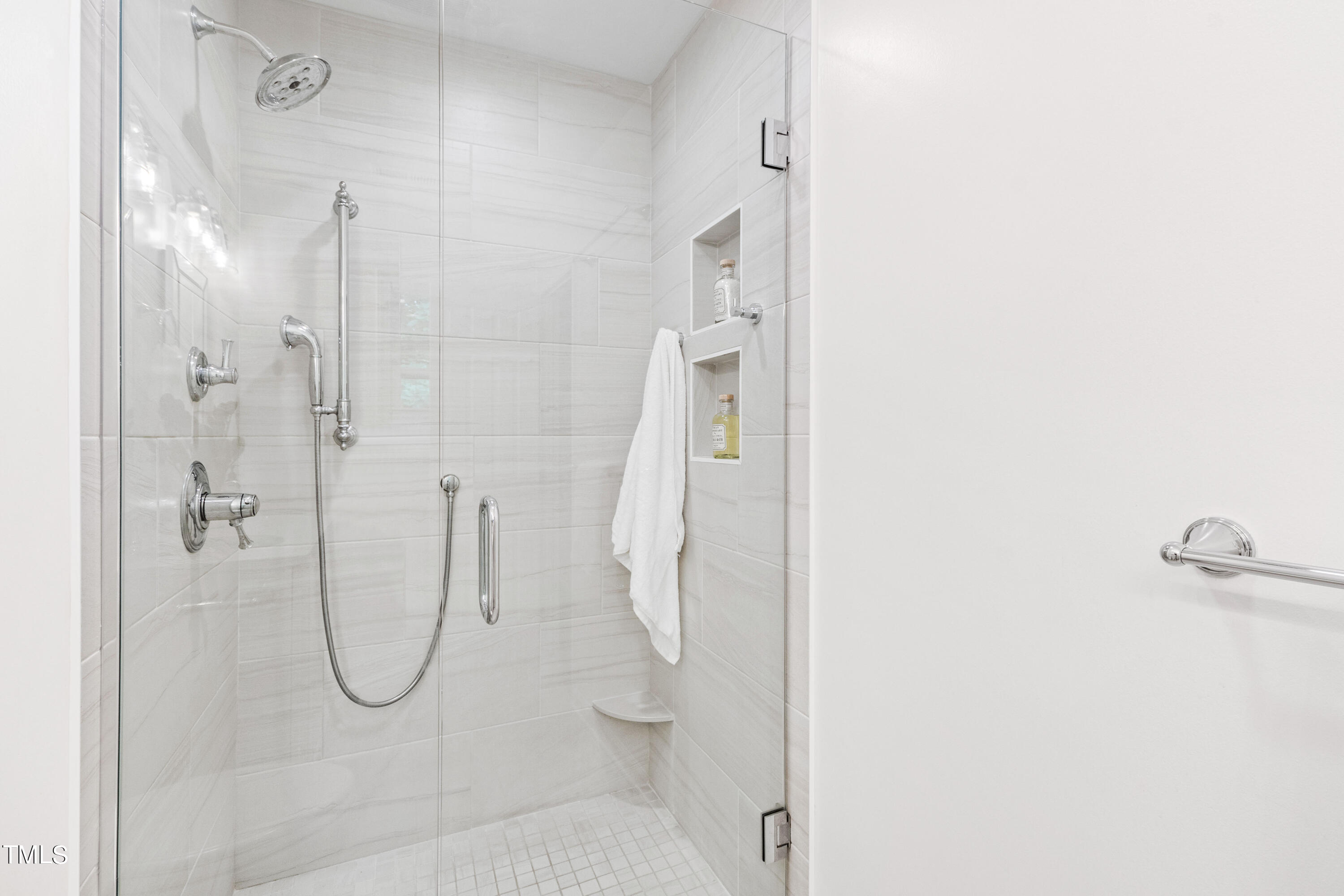 7801 Blackwing Court Raleigh, NC 27615 - Photo 28 of 40 a bathroom with a glass shower door