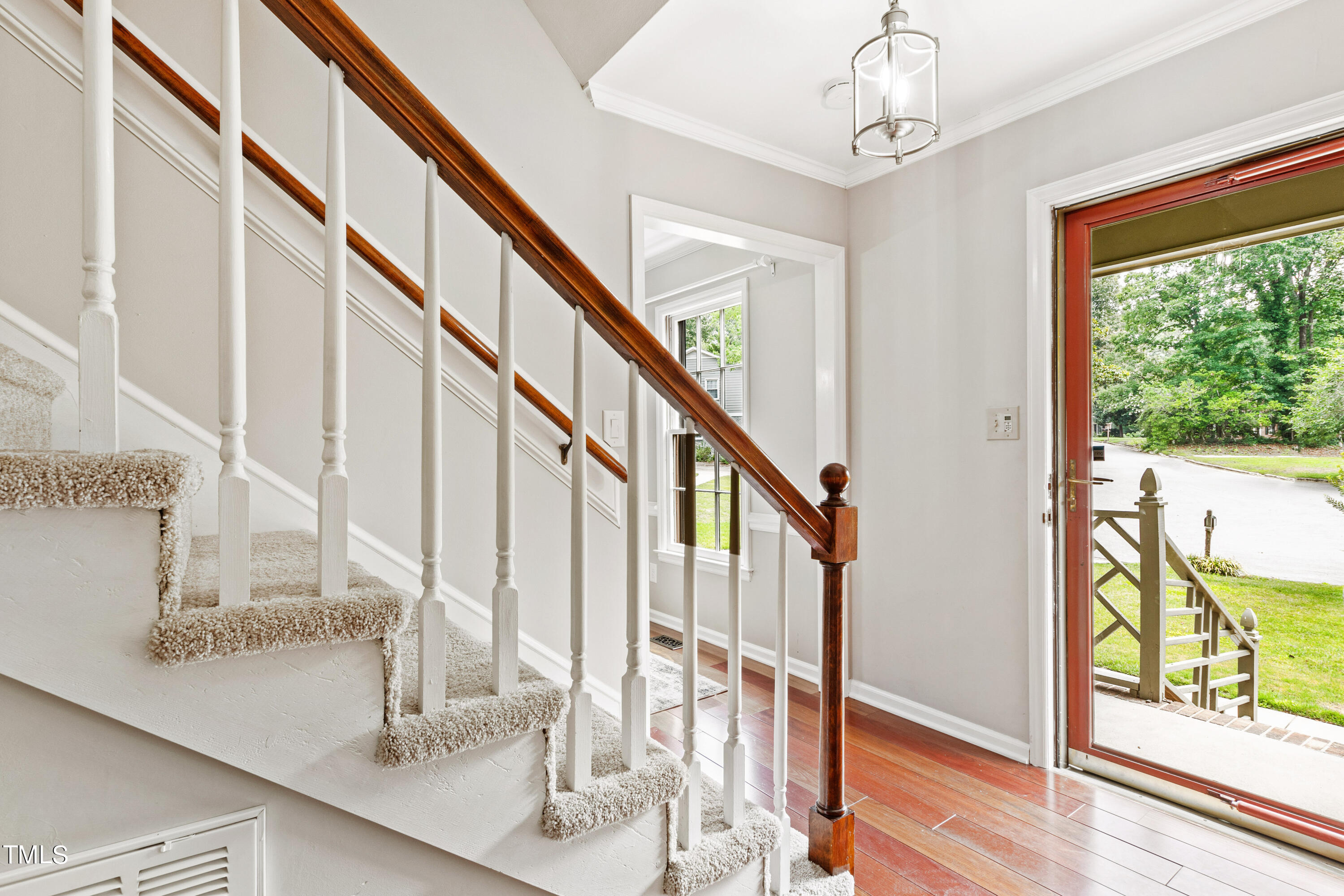 7801 Blackwing Court Raleigh, NC 27615 - Photo 6 of 40 a view of entryway and hall with wooden floor