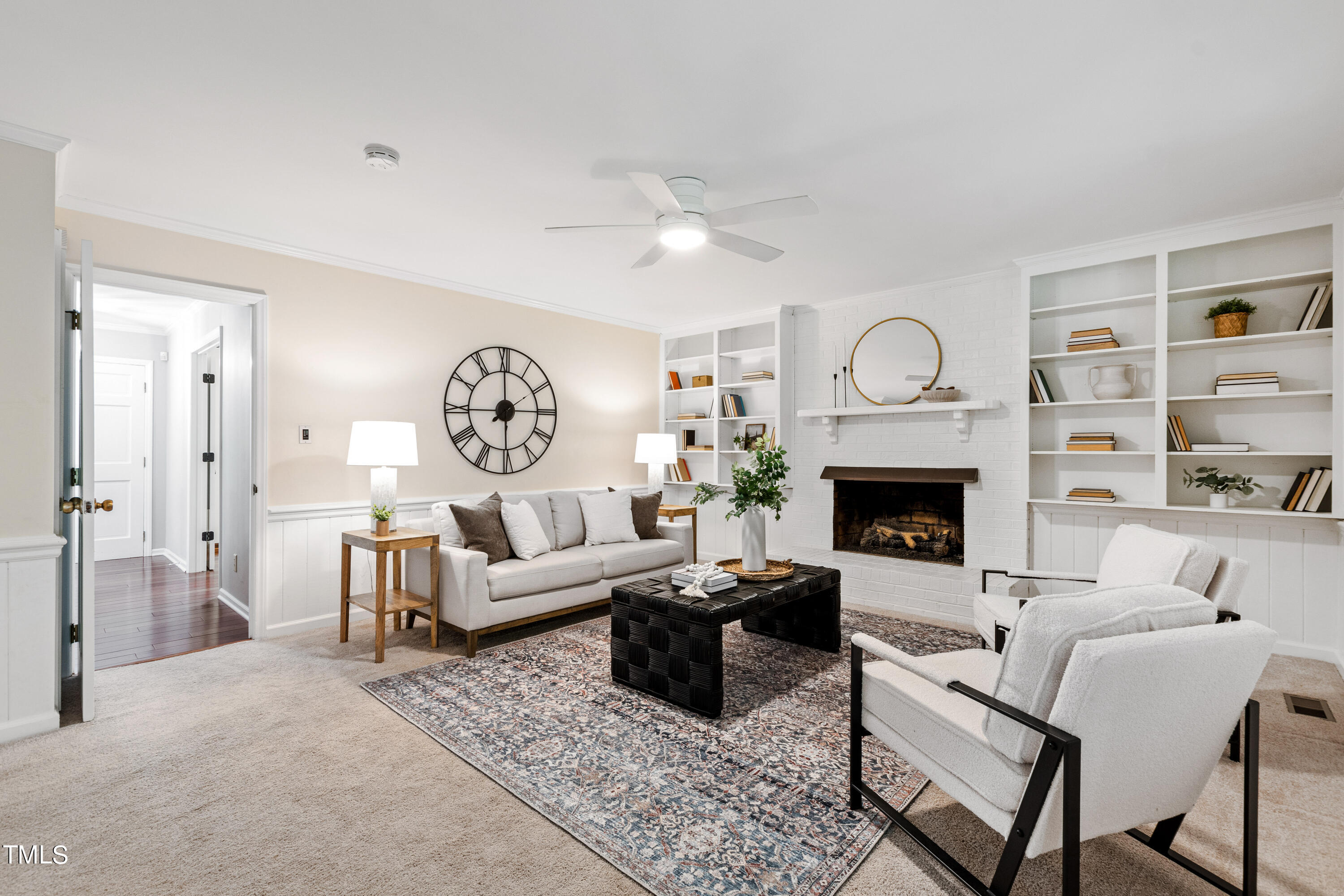 7801 Blackwing Court Raleigh, NC 27615 - Photo 10 of 40 a living room with furniture a fireplace and a large window