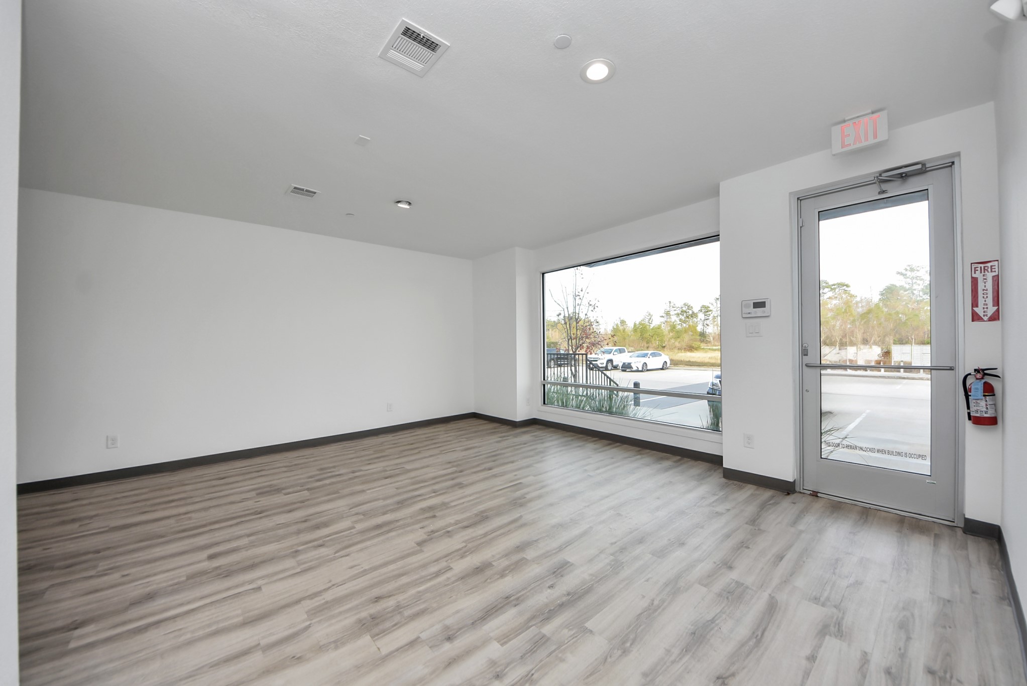 18716 Centro Main Street Conroe, TX 77385 - Photo 2 of 50 Ground-floor commercial workspace with durable flooring, neutral walls, and an open layout suitable for office, studio, or retail use.