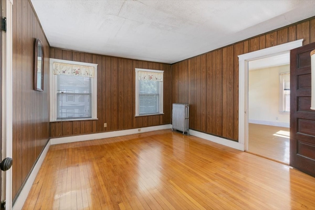 98 Webster Street Haverhill, MA 01830 - Photo 20 of 42 a view of an empty room with window and wooden floor