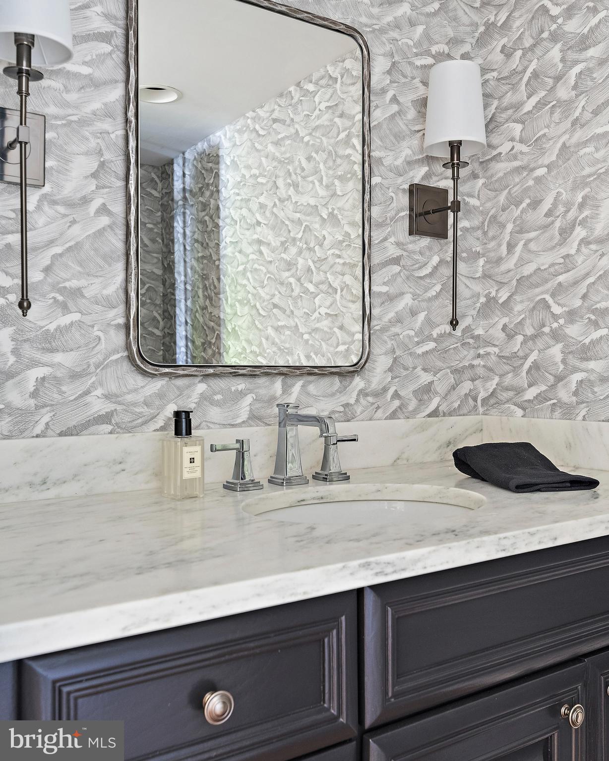 1879 Whitehall Road Annapolis, MD 21409 - Photo 36 of 78 a bathroom with a sink and a mirror