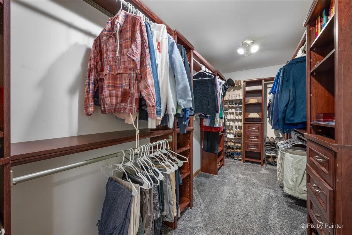 7104 Dove Way Cary, IL 60013 - Photo 33 of 82 a view of walk in closet with clothes and shoes