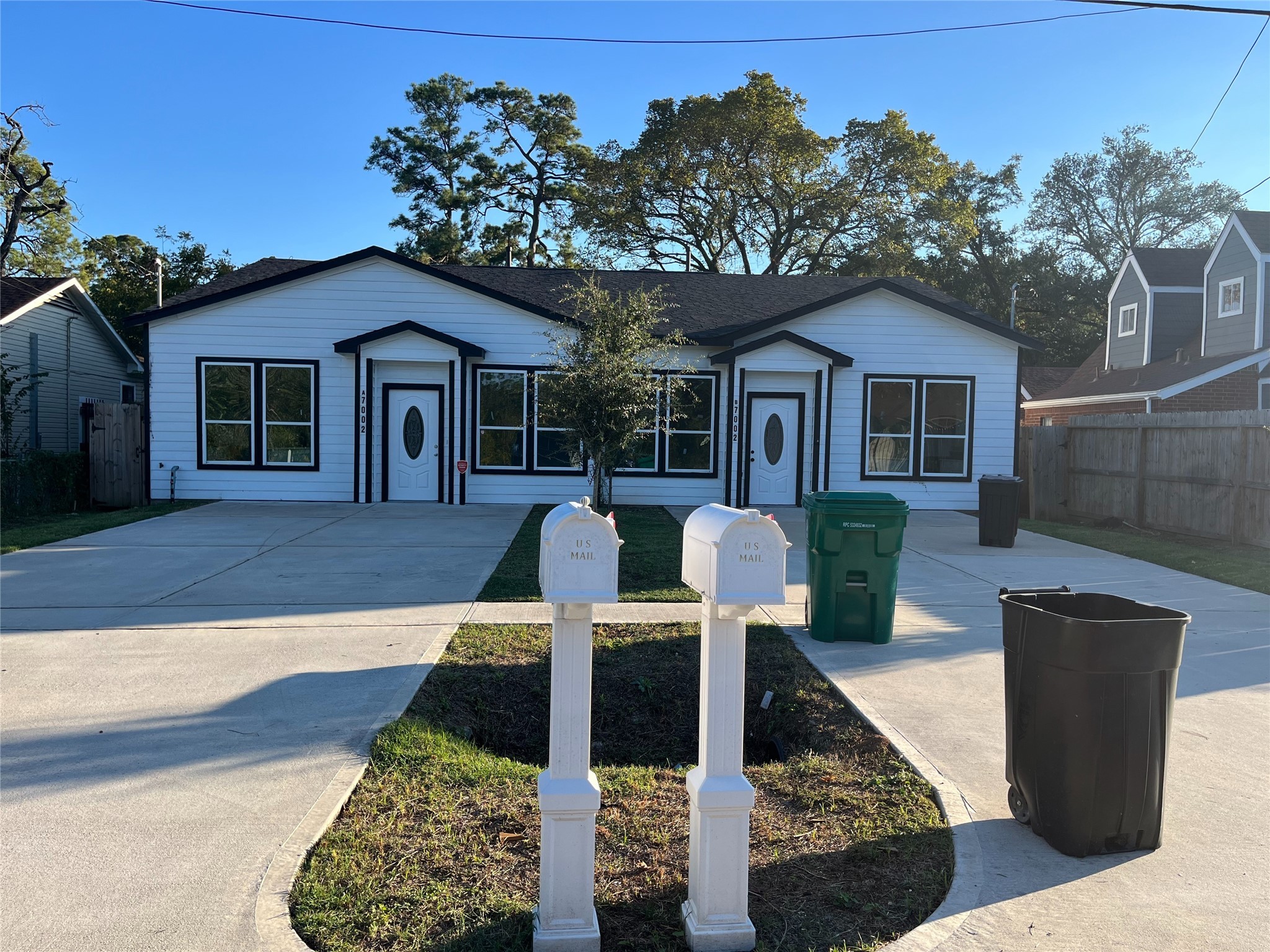 6908 South Hall Street Houston, TX 77028 - Photo 3 of 6 a front view of house with yard and trees in the background