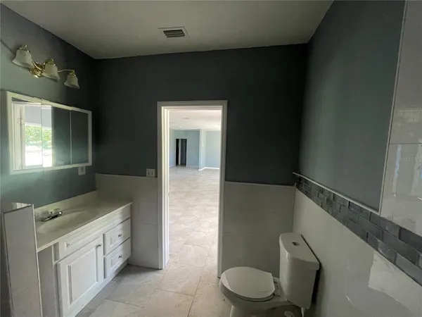 a bathroom with a toilet and a window