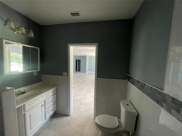 a bathroom with a toilet and a window