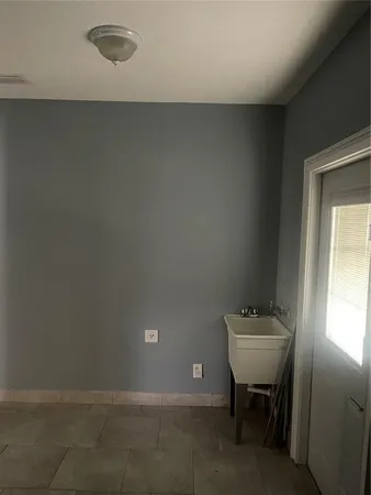 a view of an empty room with a kitchen