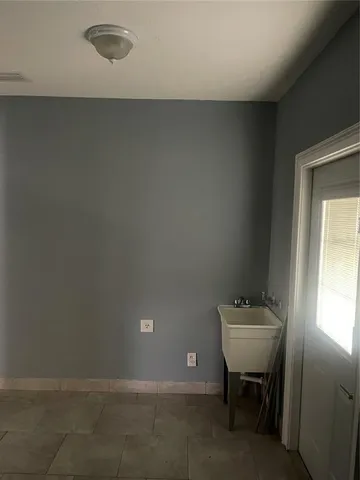 a view of an empty room with a kitchen