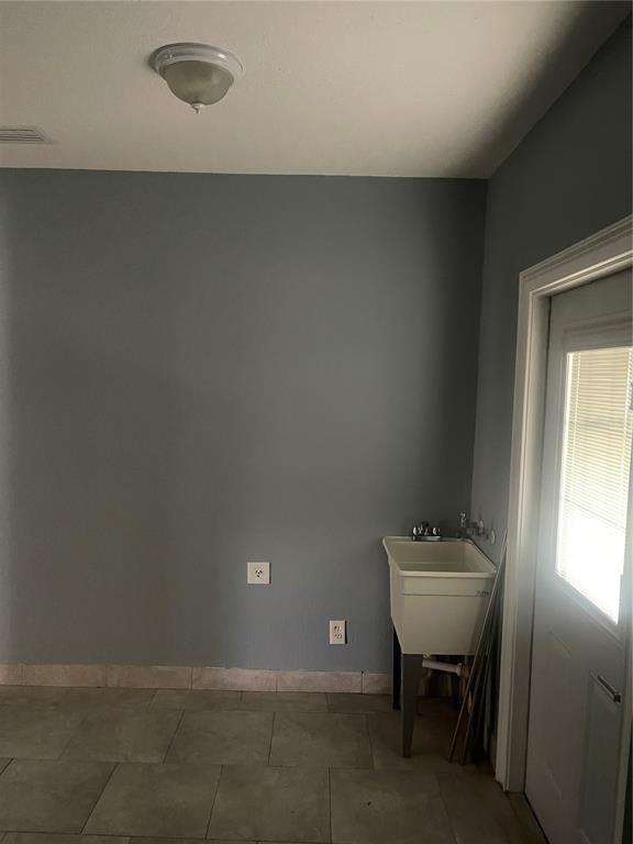 8704 Jackson Springs Road Tampa, FL 33615 - Photo 16 of 21 a bathroom with a sink toilet and mirror