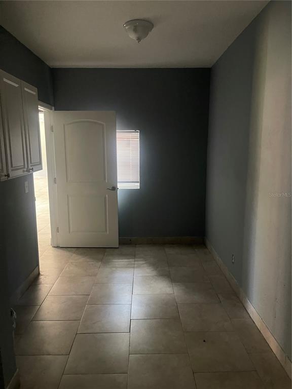 8704 Jackson Springs Road Tampa, FL 33615 - Photo 17 of 21 a view of an empty room with a kitchen
