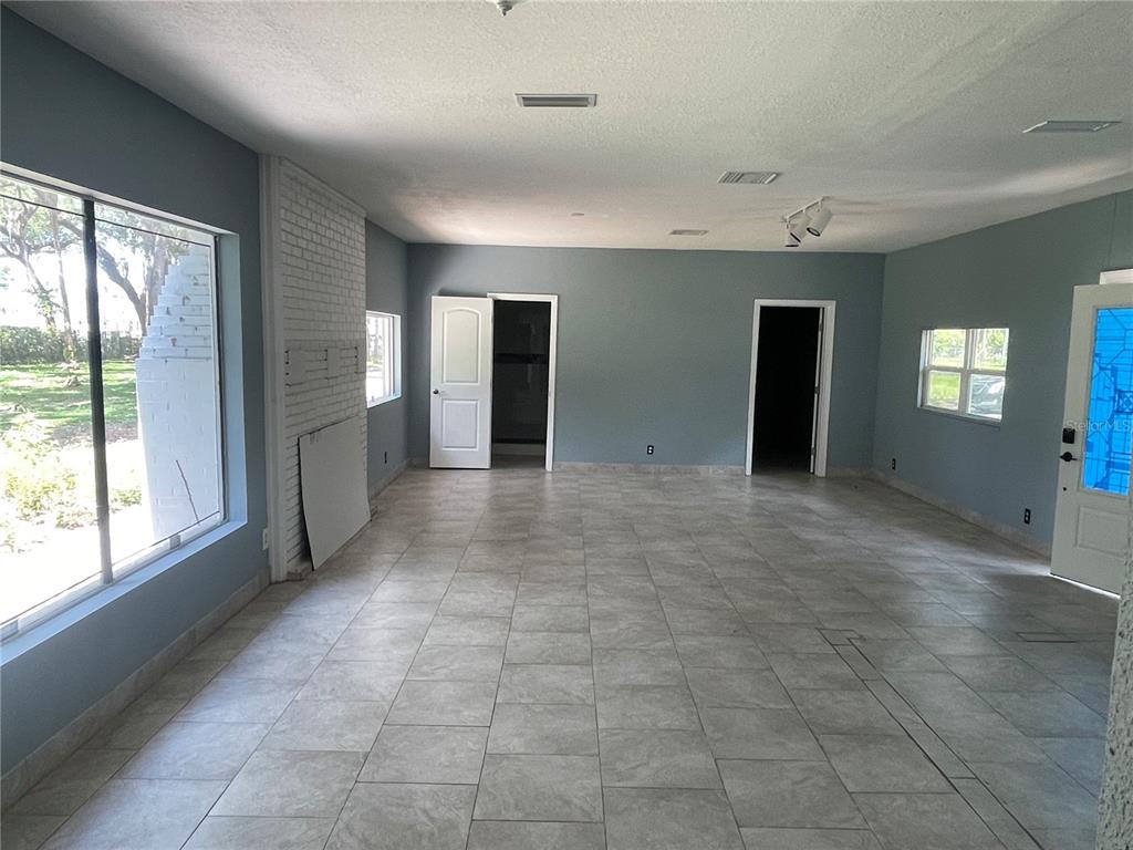 8704 Jackson Springs Road Tampa, FL 33615 - Photo 6 of 21 a view of an empty room with window and chandelier