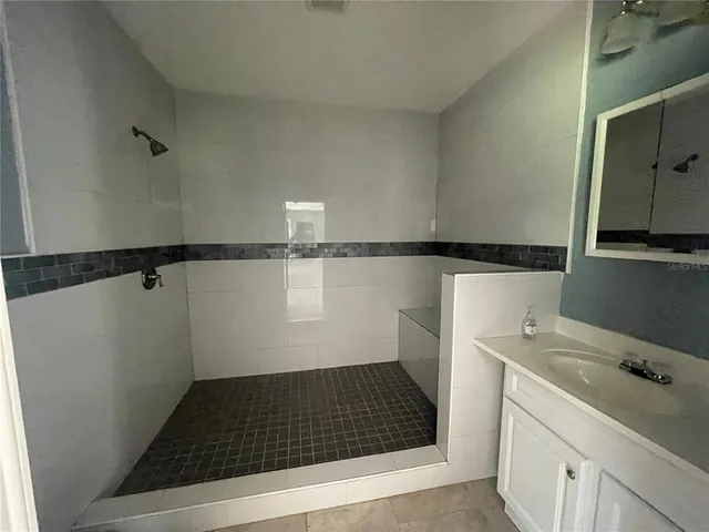 a bathroom with a shower and a stove