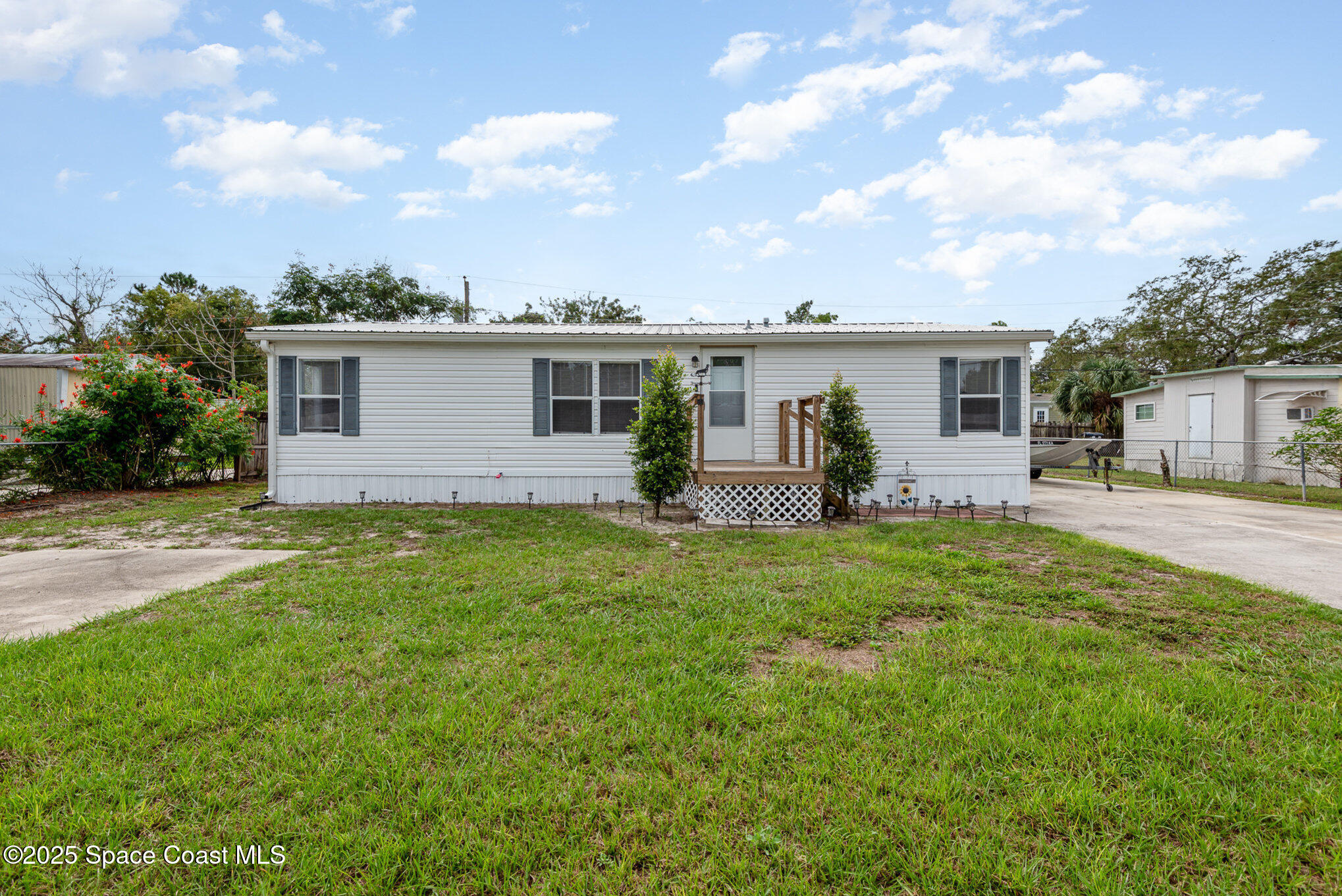 3115 Brockett Road Mims, FL 32754 - Photo 1 of 15 a view of a house with backyard and sitting area
